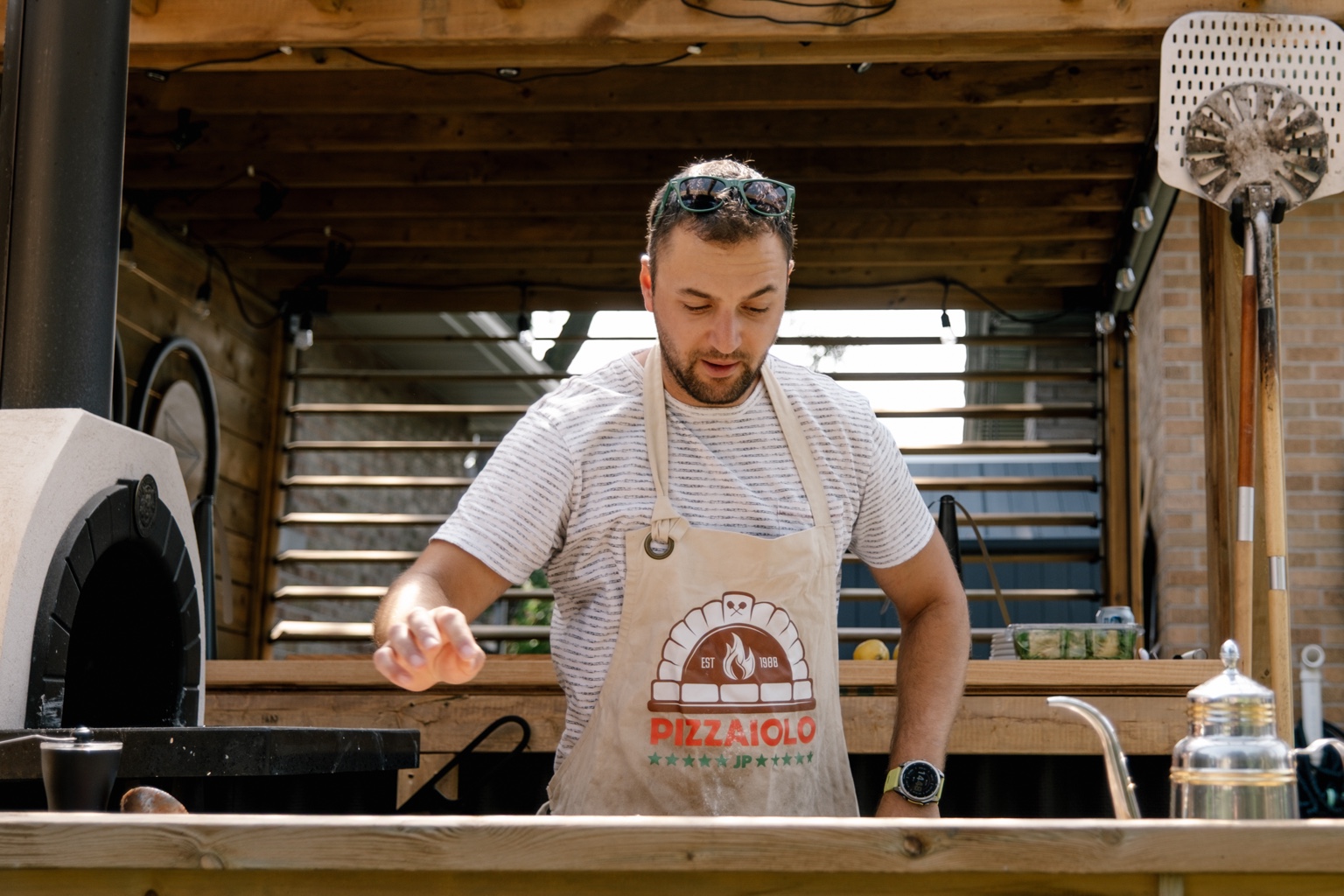 Making pizza beside the wood oven